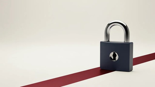 A closed navy padlock with a polished steel shackle standing on a pale studio floor, a red stripe running diagonally behind it.